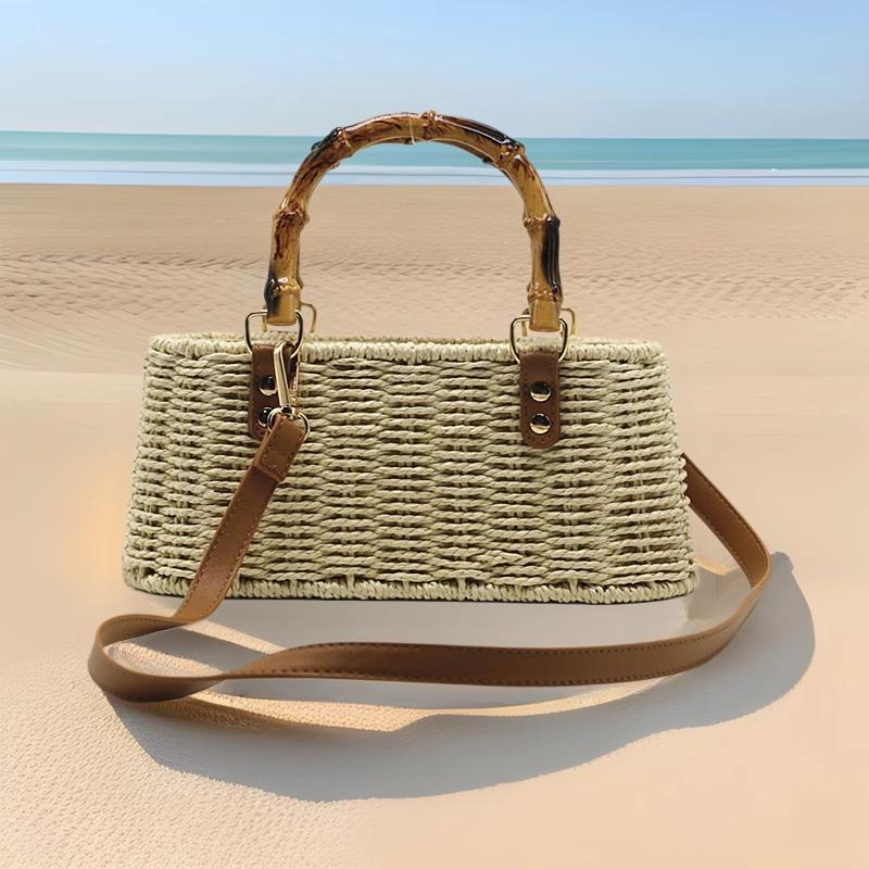 Sac en paille cabas Rosemonde avec poignée en bambou et bandoulière en cuir marron posé sur le sable face avant