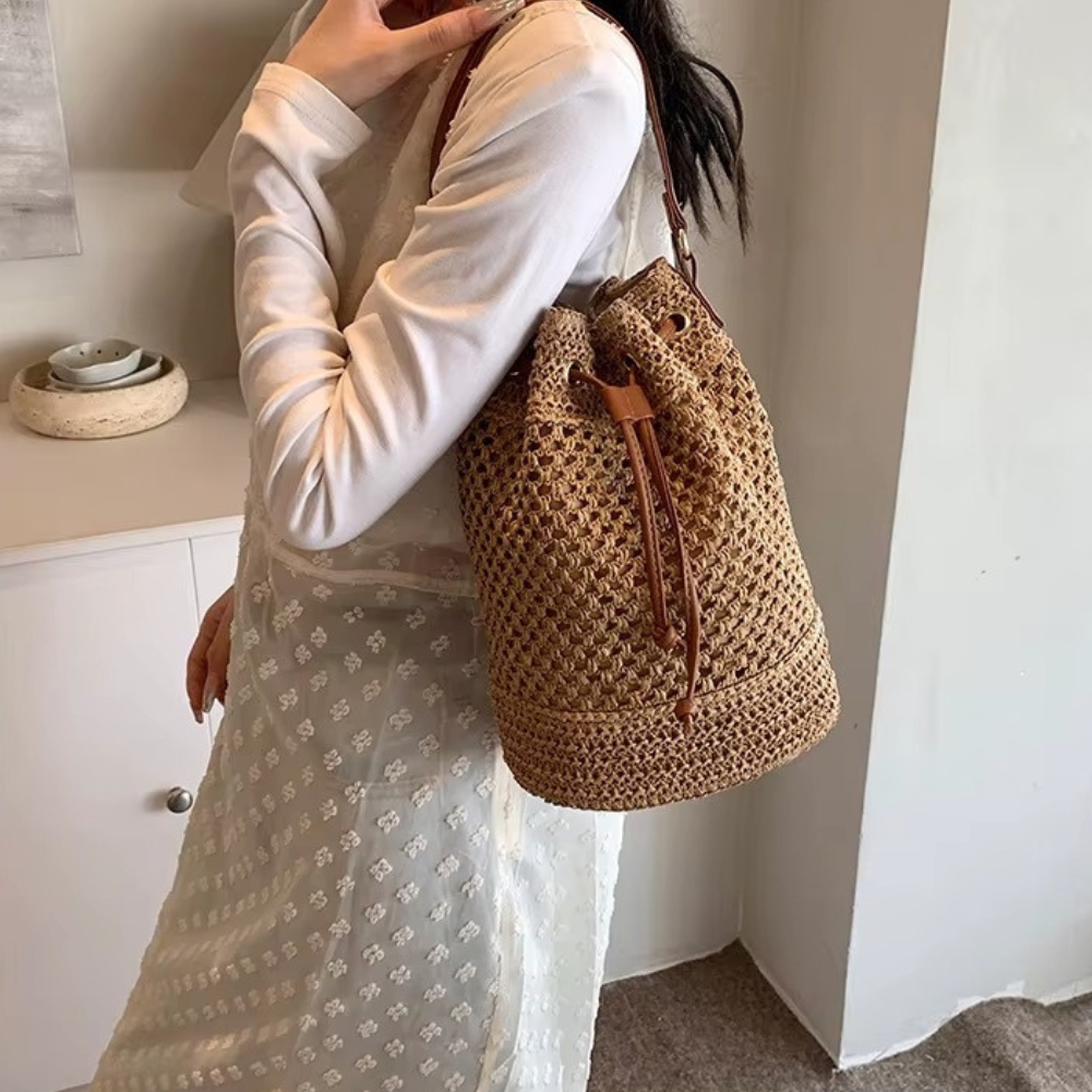 Sac en paille seau ajouré avec cordon coulissant porté à l'épaule, couleur naturelle